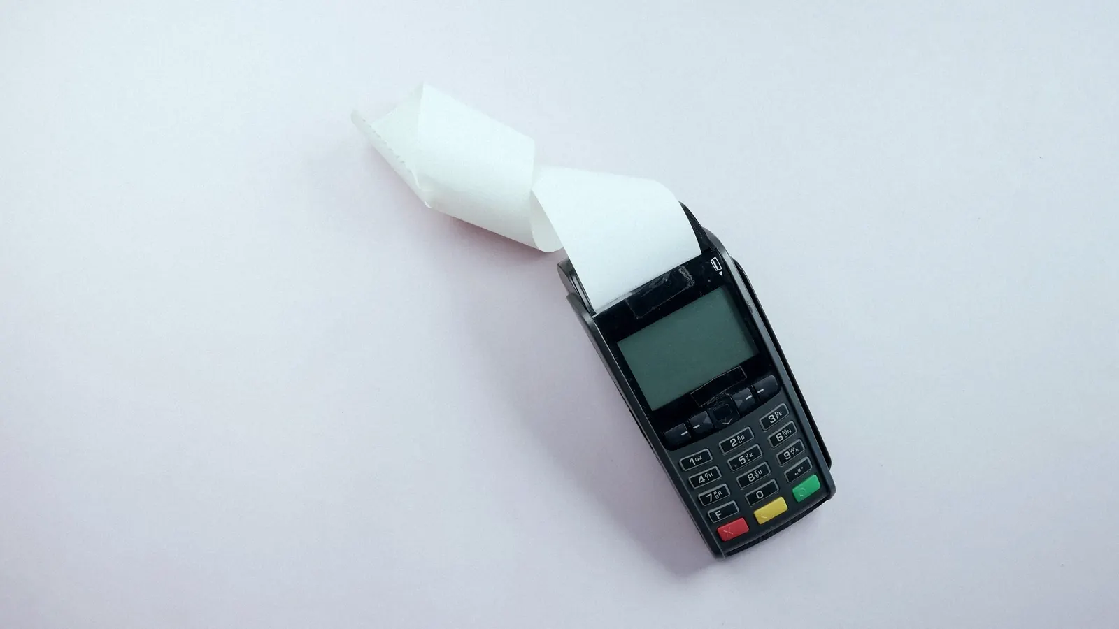 A card payment terminal printing a receipt.
