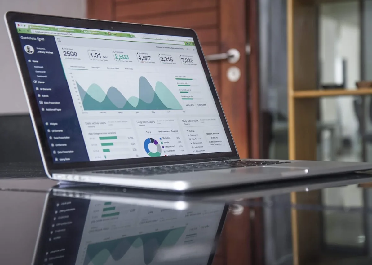 A laptop screen showing digital accounting dashboards and financial data.