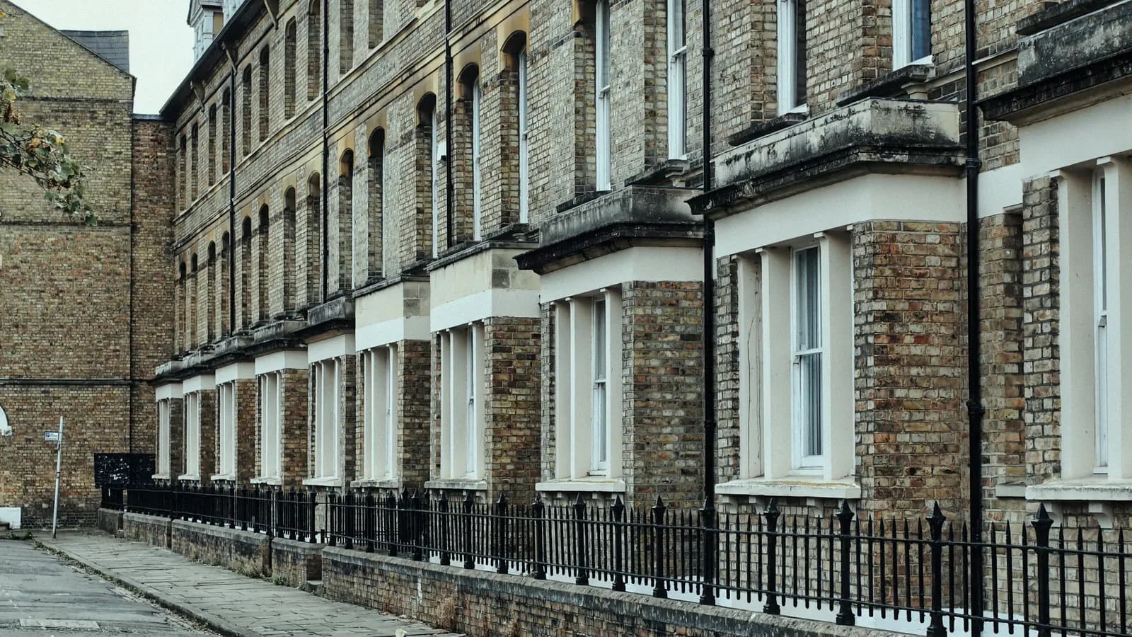 A row of Victorian brick terraced houses.